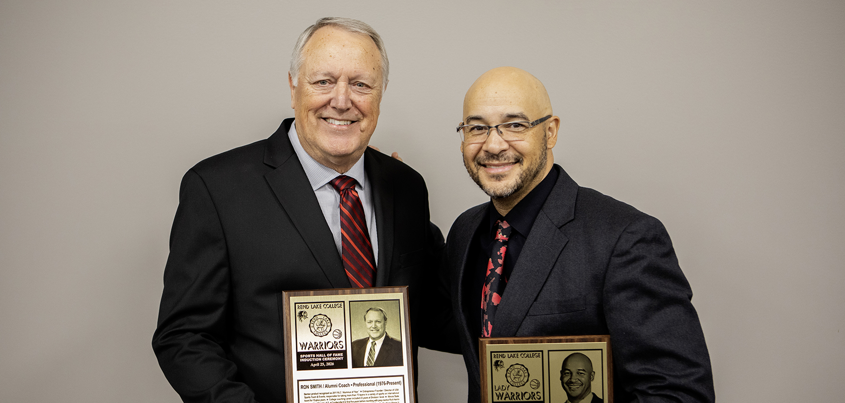 Ron Smith and Glenn Box holding their Hall of Fame plaques on April 25, 2026